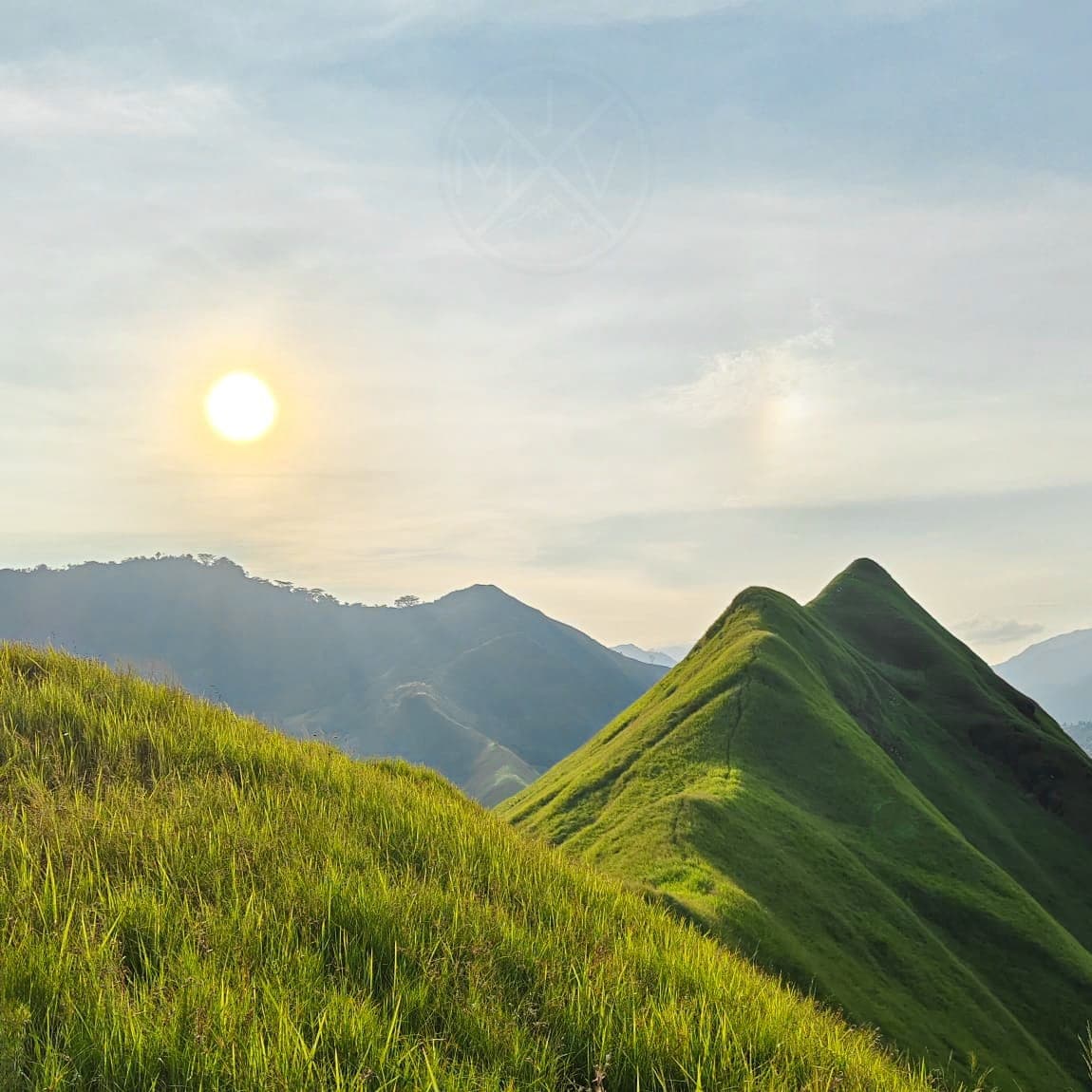 Sunrise over the grass-covered twin ridges of Mt. Kulago in Impasugong